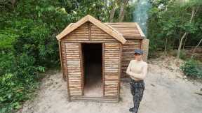 Building Survival Log Cabin Bushcraft Shelter With Wooden Roof , Clay Fireplace In Wilderness