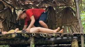 Wild survival girl makes shelter and fishes.